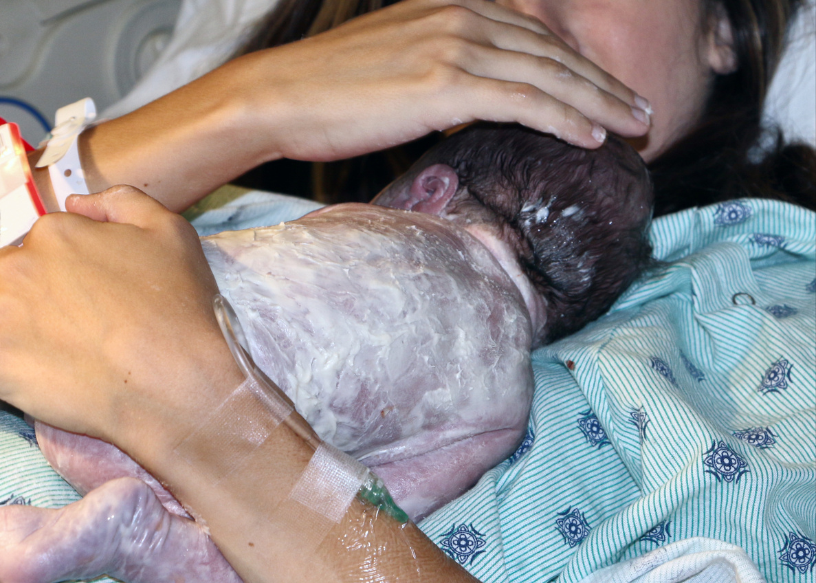 Newborn baby moments after childbirth - stock photo